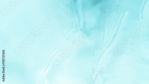 Freeze motion of splashing water surface on light blue background