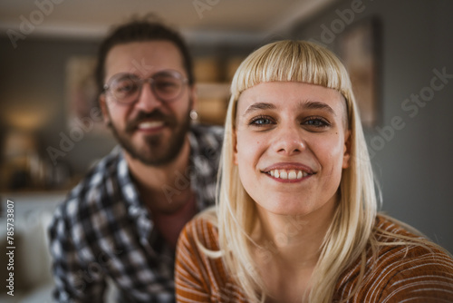 Portrait of adult couple hug and smile at home happy together