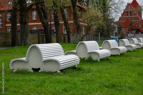 white decorative benches in city park on shore Baltic Sea. Puck, Poland
