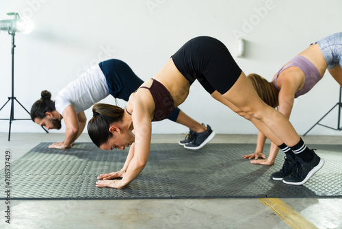 Group of three people doing planks in fitness class