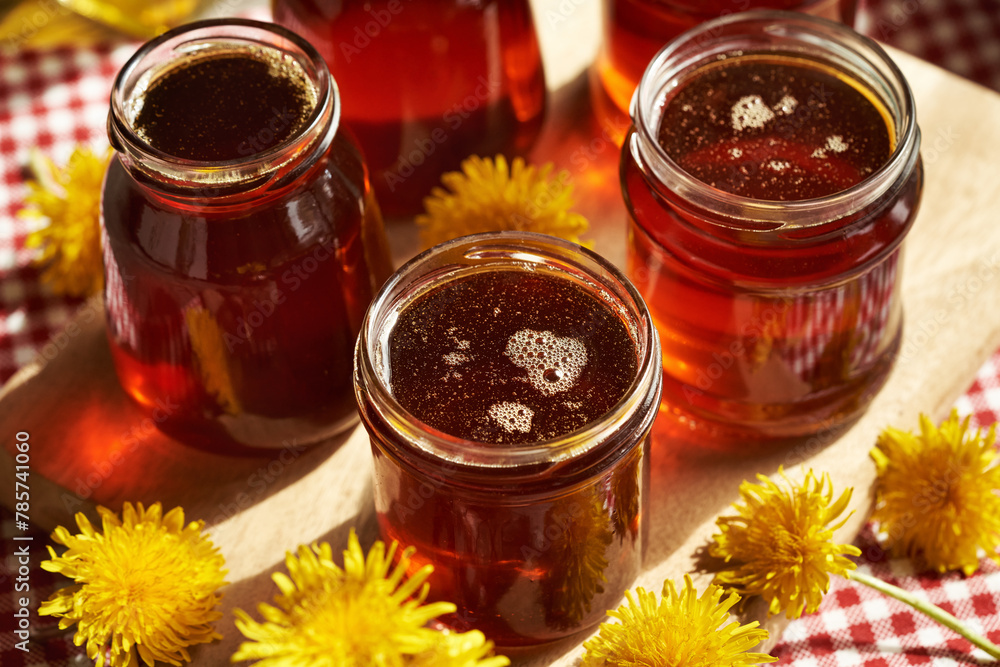 Several jars of dandelion honey - syrup made of fresh dandelion flowers in spring Several jars of dandelion honey - syrup made of fresh dandelion flowers in spring