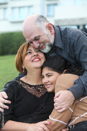 Family of three. Happu mature couple with teenage daughter at the park. ature couple photo