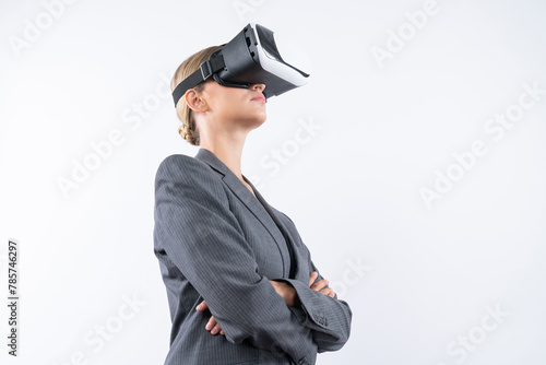 Businesswoman crossing arms while wearing VR glasses at white background. Skilled project manager checking at financial graph while using visual reality goggles. Innovation technology. Contraption.