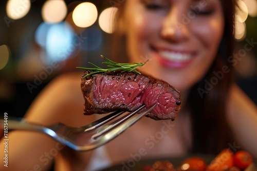 High-definition close-up of a woman enjoying a forkful of tender, succulent steak