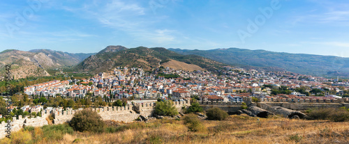 Detailed panoramic view of Selcuk town with ancient walls, lush hills, clear skies, travel and culture themes. Banner. Selcuk, Izmir, Turkiye (Turkey)