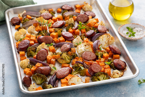 Sheet pan dinner with sausage and vegetables roasted and ready to eat