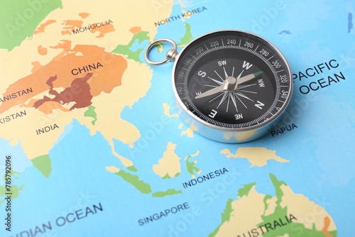 One compass on world map, space for text. Tourist equipment