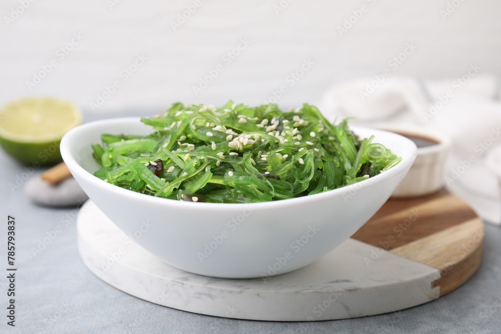 Tasty seaweed salad in bowl on gray table, closeup Tasty seaweed salad in bowl on gray table, closeup