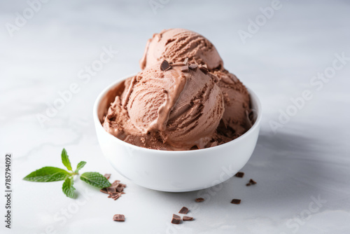 Chocolate ice cream in a white bowl on white table with copy space minimalistic style