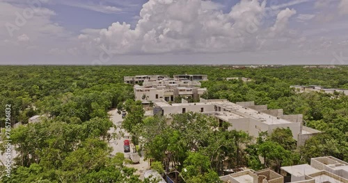 Tulum Mexico Aerial v9 low drone flyover newly developed upscale neighborhood, luxury homes, building complex with rooftop pools surrounded by lush greenery - Shot with Mavic 3 Pro Cine - July 2023 photo