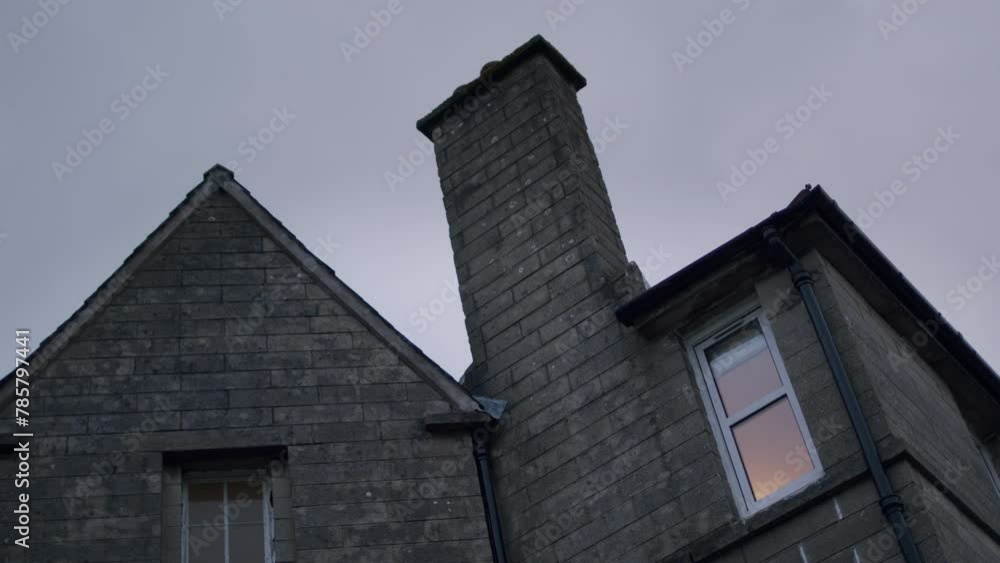 View of a traditional old stone house in England. Low angle shot of building exterior with. View of a traditional old stone house in England. Low angle shot of building exterior with.