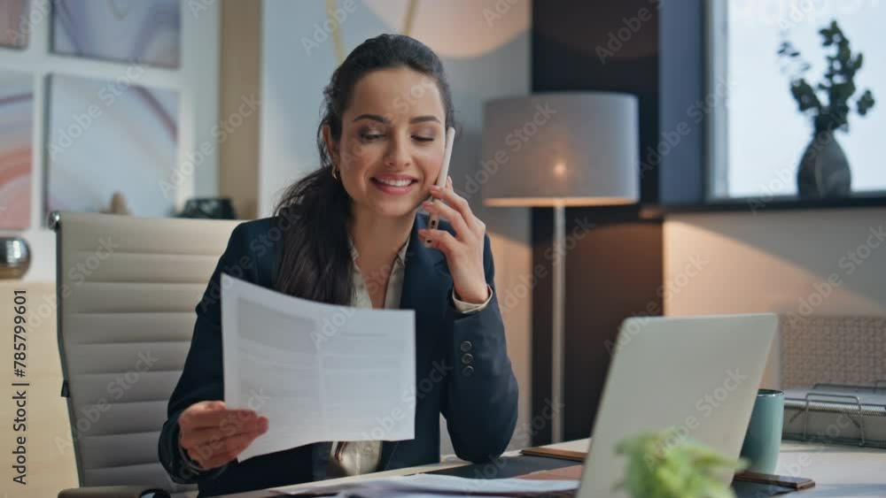 Happy manager calling smartphone looking papers office. Smiling woman speaking Happy manager calling smartphone looking papers office. Smiling woman speaking