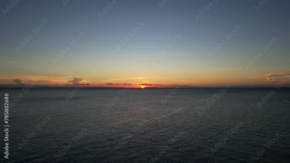 Blurry image of sunset reflecting on ocean water with afterglow in sky Nungwi Kendwa Zanzibar Drone view Tanzania Africa Blurry image of sunset reflecting on ocean water with afterglow in sky Nungwi Kendwa Zanzibar Drone view Tanzania Africa