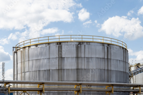 the top of a white rusty streaked petro chemical tank at a refinery photo