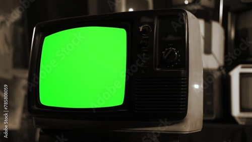 An Old TV Turning On Chroma Key Green Screen. Sepia Tone. Close Up. You can replace green screen with the footage or picture you want with “Keying” effect in After Effects. photo