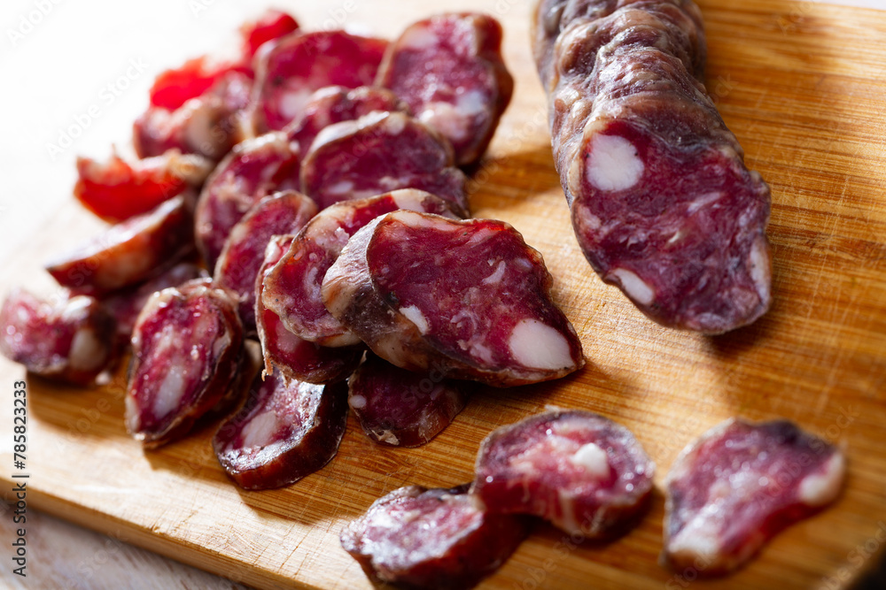Traditional French dried sausage on cutting board. High quality photo