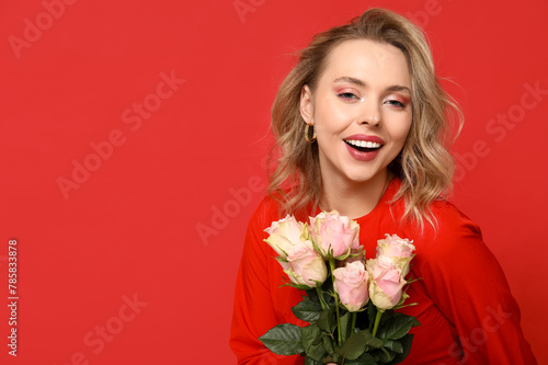 Happy young woman with bouquet of beautiful roses on red background © Pixel-Shot