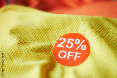 25 discount sakes tag on yellow color cloth  photo