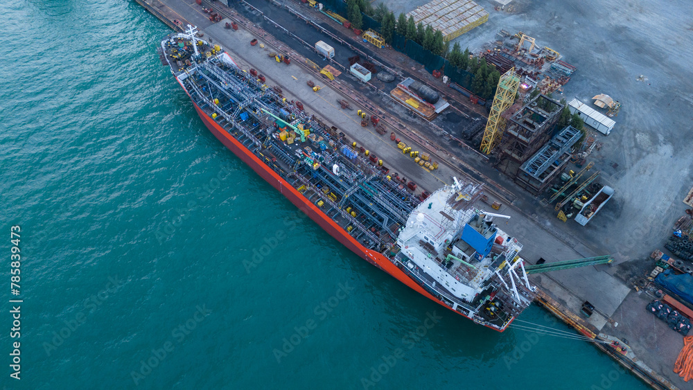 Oil tanker ship at dry dock concept maintenance service. working at dry dock. Insurance and Maintenance Crude tanker Ship concept. Freight Forwarding Service maintenance Insurance..