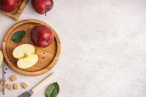 Wooden plate with fresh red apples on white background © Pixel-Shot