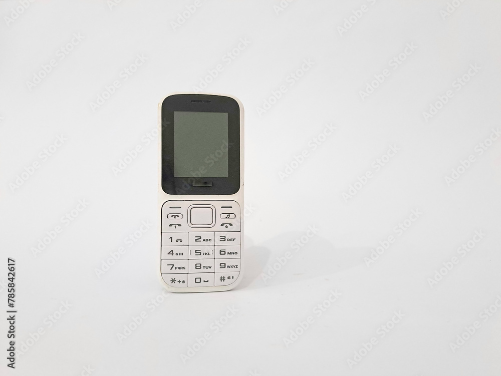 White old handphone on white background. This phone has a classic design before the smart
White old handphone on white background. This phone has a classic design before the smart