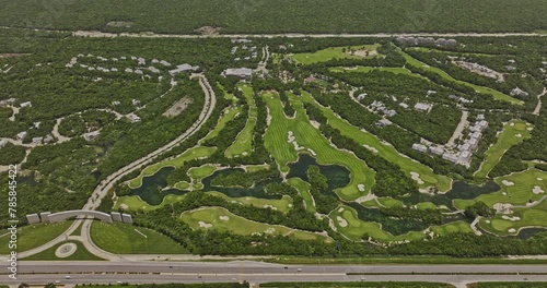 Akumal Mexico Aerial v20 high birds eye view flyover golf course with luxury resorts and homes surrounded by lush Mayan jungle and ocean views - Shot with Mavic 3 Pro Cine - July 2023 photo