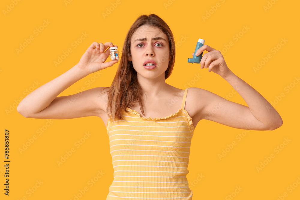 Young woman with jar of pills and inhaler on yellow background Young woman with jar of pills and inhaler on yellow background