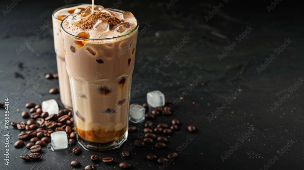 Ice coffee in a tall glass with cream poured over, ice cubes and beans on a dark concrete table. Cold summer drink with tubes Ice coffee in a tall glass with cream poured over, ice cubes and beans on a dark concrete table. Cold summer drink with tubes
