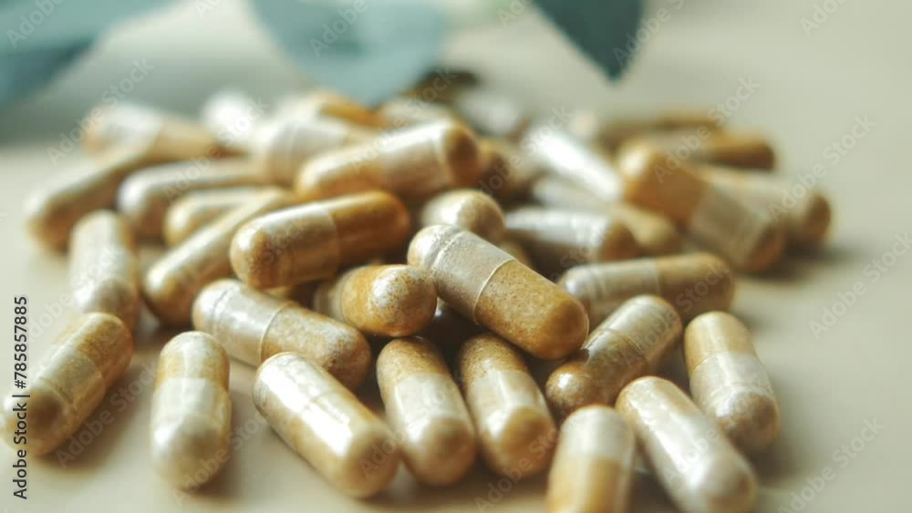 herbal medicine capsule dropping on table herbal medicine capsule dropping on table