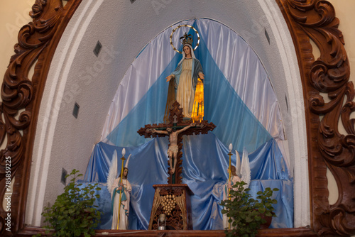 Photo of sculpture of virgin mary inside a church.