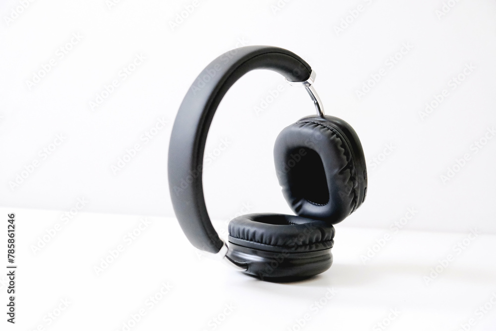 Black headphones on a white background. Stylish headphones, copy space Black headphones on a white background. Stylish headphones, copy space