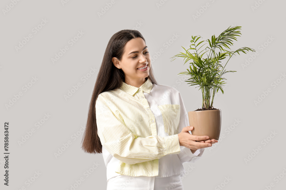 Young happy woman with houseplant on white background Young happy woman with houseplant on white background