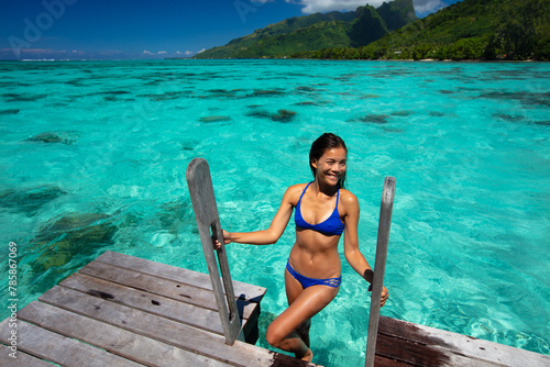 Island Bliss: Sunlight Dances on Crystal Waters as a Woman Savors Her Ocean Getaway Travel Vacation