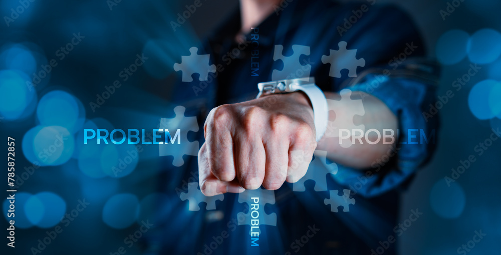 A man is punching a puzzle piece with the words problem on it A man is punching a puzzle piece with the words problem on it