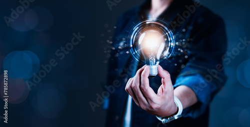 A person is holding a light bulb in their hand