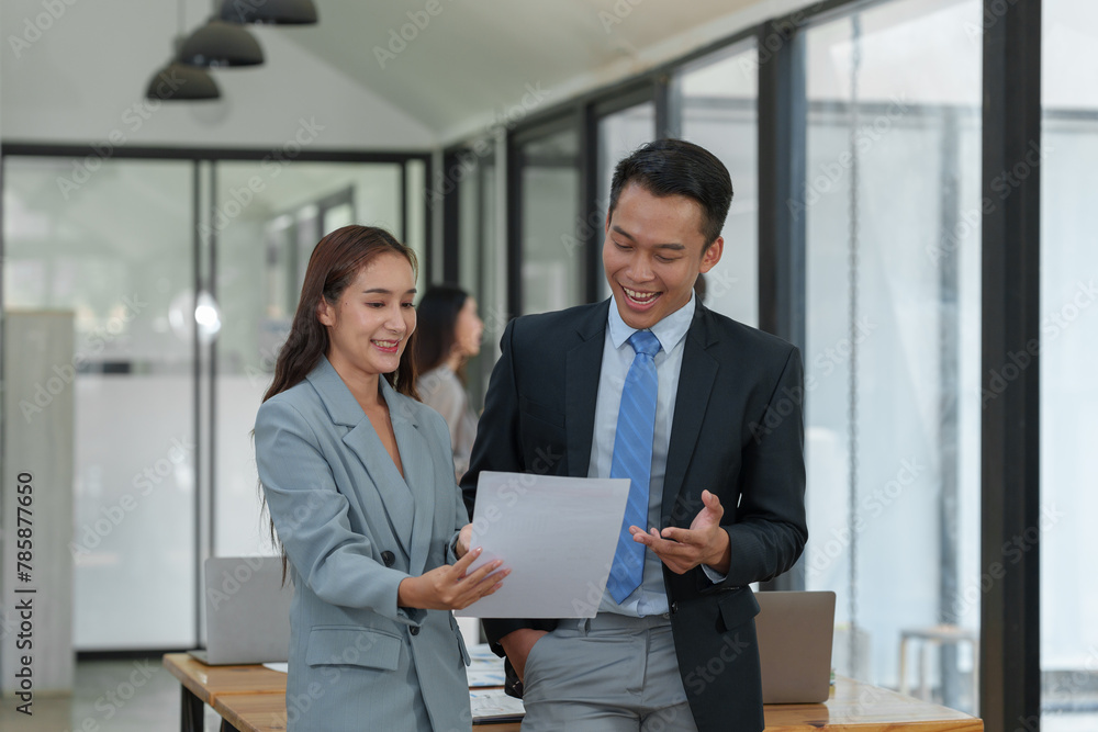 The creative team, a man, and two Asian women smile and talk. Discuss numbers financial information and calculations. online marketing Tracking the company's operating results and profits. The creative team, a man, and two Asian women smile and talk. Discuss numbers financial information and calculations. online marketing Tracking the company's operating results and profits.