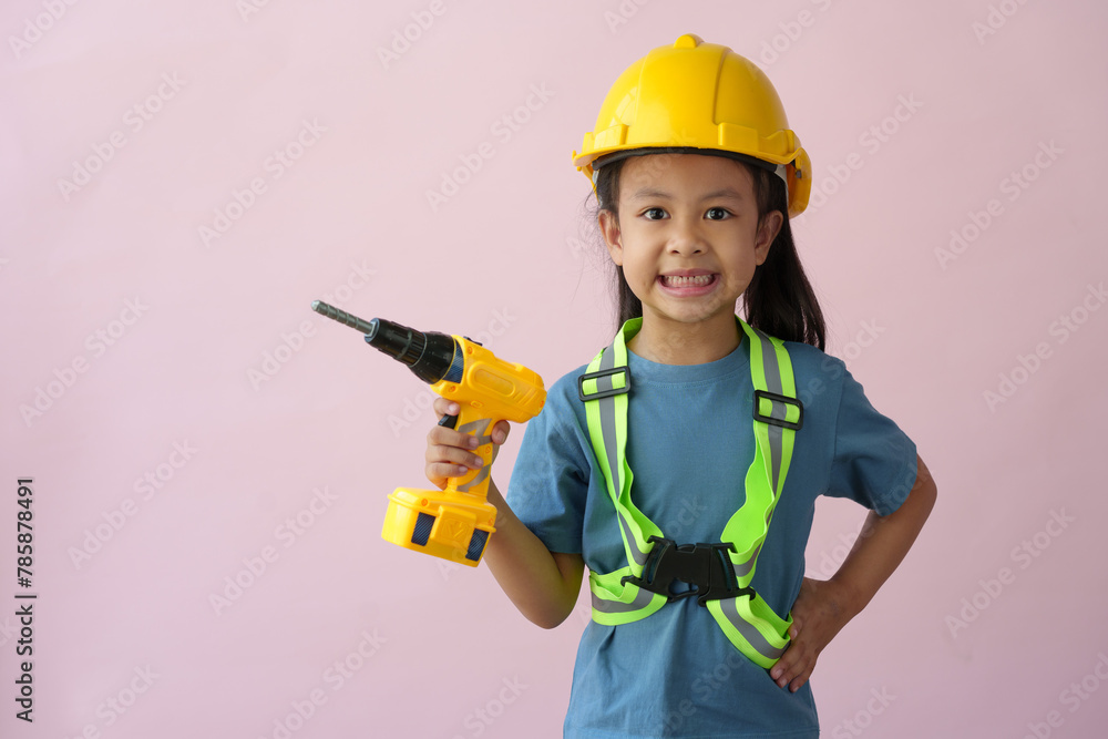 A little girl in a construction helmet and repair equipment Improving the premises About redevelopment, perspective ideas, planning, house design, architects, engineers, future careers.