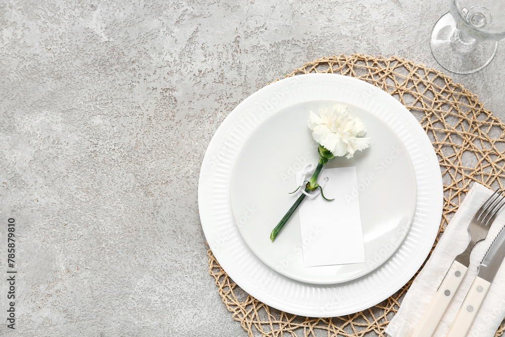 Obraz premium Table setting with beautiful flower on grey background