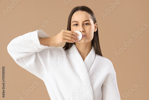 Young woman in bathrobe wit...