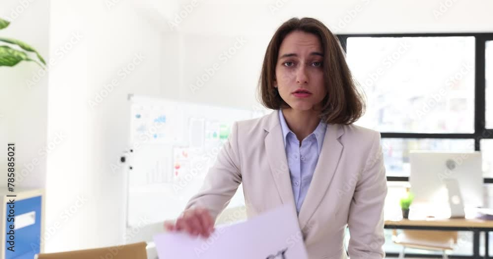 Upset angry businesswoman showing contract and indicating dismissal with finger Upset angry businesswoman showing contract and indicating dismissal with finger