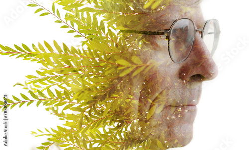 A creative double exposure profile portrait of an old man with glasses