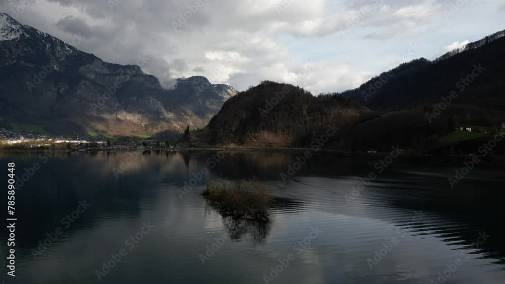 Aerial panning view of range of hills and Alps at background in Walensee, Switzerland. Aerial panning view of range of hills and Alps at background in Walensee, Switzerland.