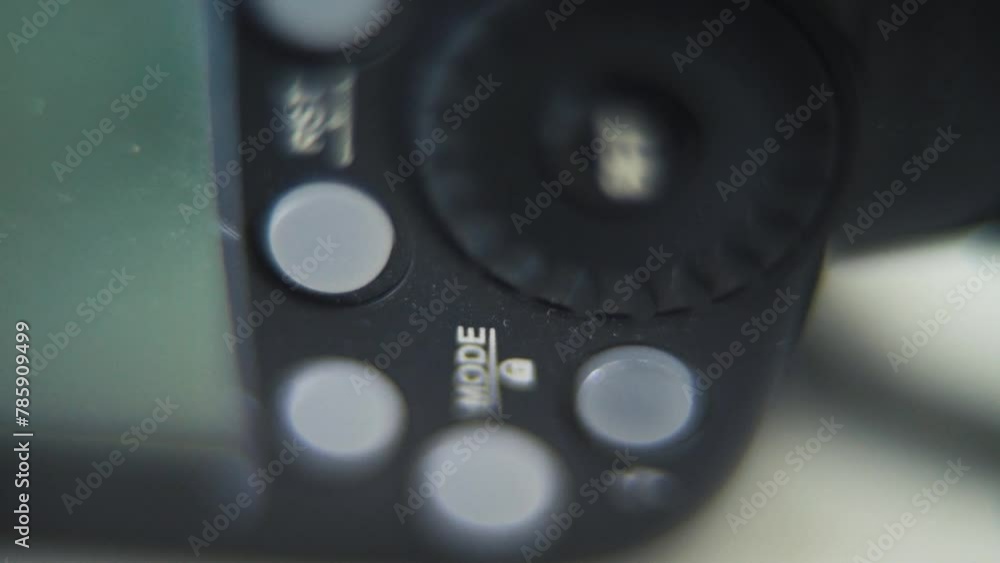 Macro vertical shot of a Speedlight, flash light, camera gear, buttons and screen, tilt up crane movement, slow motion 120fps, Full HD Macro vertical shot of a Speedlight, flash light, camera gear, buttons and screen, tilt up crane movement, slow motion 120fps, Full HD