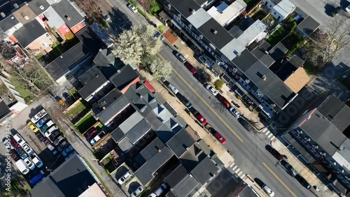 Aerial reveal of urban houses and church with trees blossoming in spring. American city during April. photo