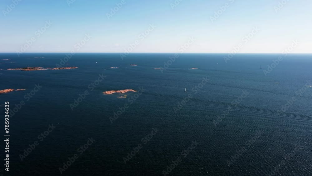 Aerial view away from a sailboat sailing in middle of rocky isles, on the Gulf of Finland Aerial view away from a sailboat sailing in middle of rocky isles, on the Gulf of Finland