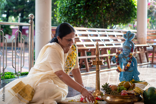 A Picture of middle aged malayali man and woman making Vishu kani
