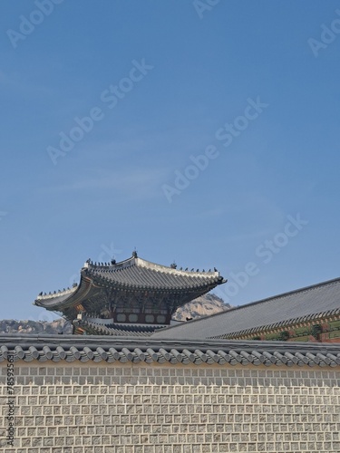 Traditional Korean tile capped old stone wall of the palace in the downtown district Seoul, South Korea 