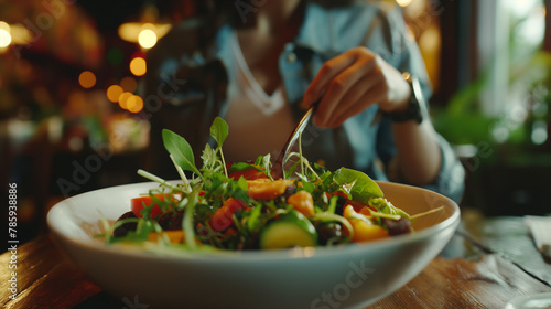 Zooming in on the delectable details, a customer is seen relishing a vegetable salad served in a restaurant, their enjoyment evident as they partake.
