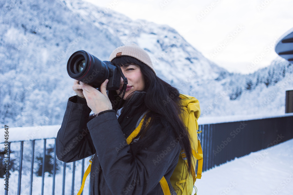Outdoor Photographer Capturing Snowy Mountain Scenery