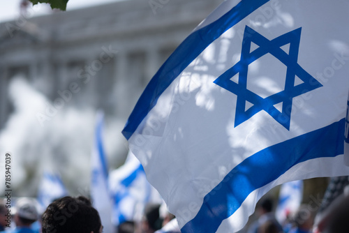 Demonstrators wave Israeli flags in front of San Francisco City Hall.